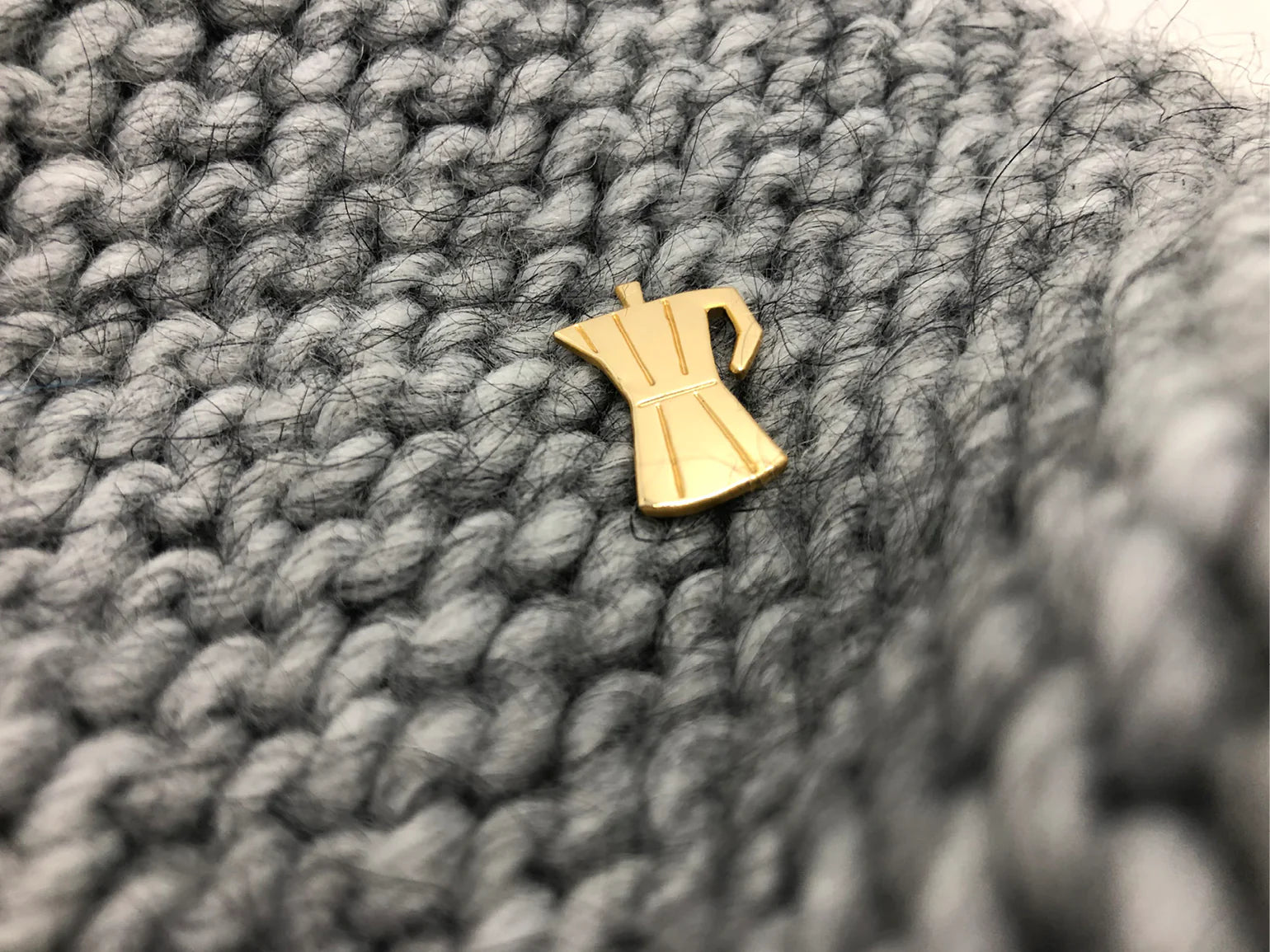 gold plated handmade coffee pot pin by Typealive, on grey knit