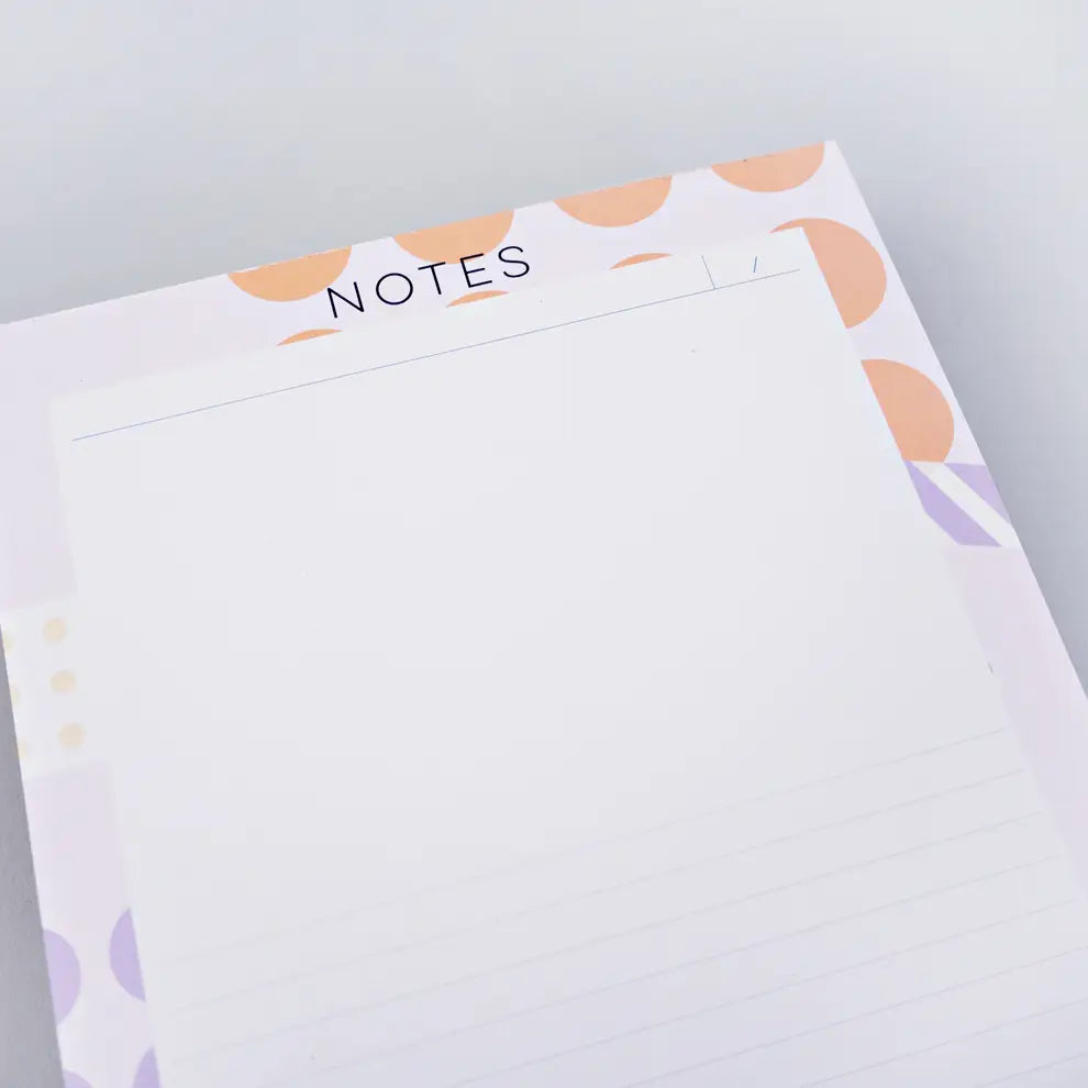 top of note pad ephemera by the completist, with abstract lilac and orange dots