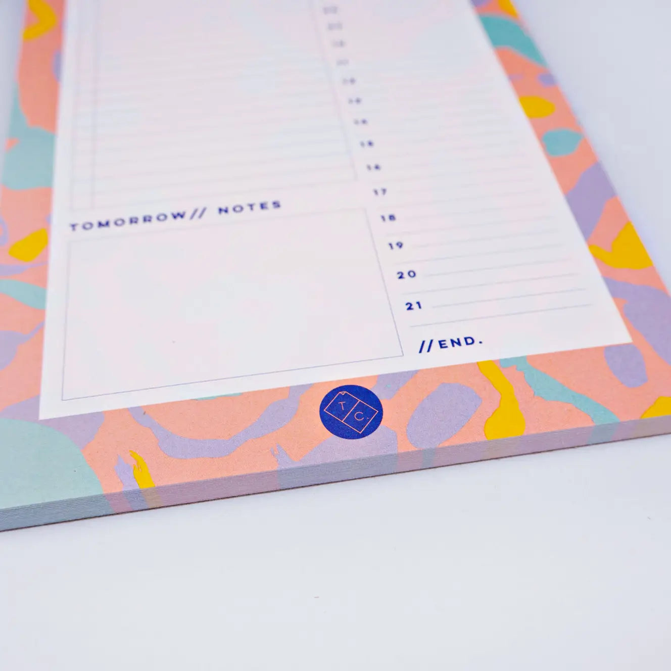 bottom of planner pad Inky by the completist, with swirls of yellow, orange, mint and purple