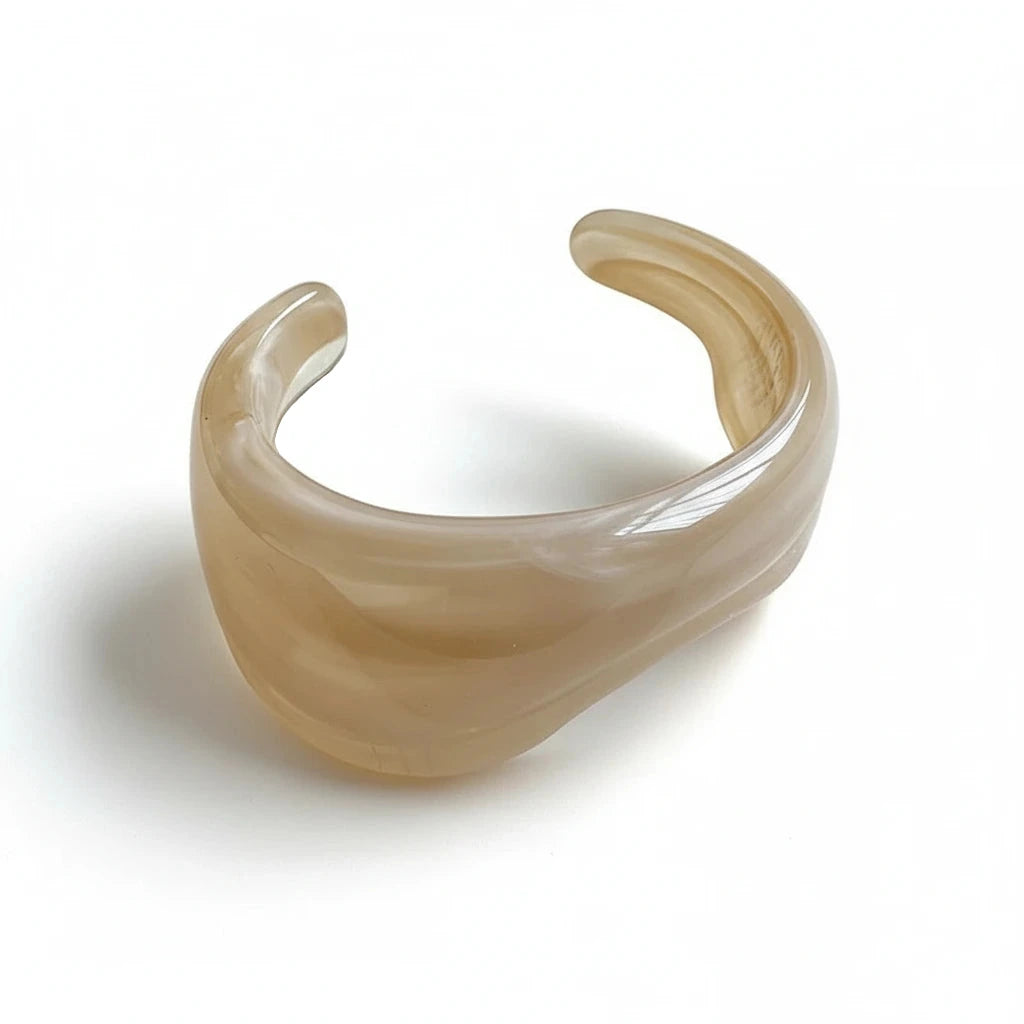 Cream resin cuff bracelet on a white surface