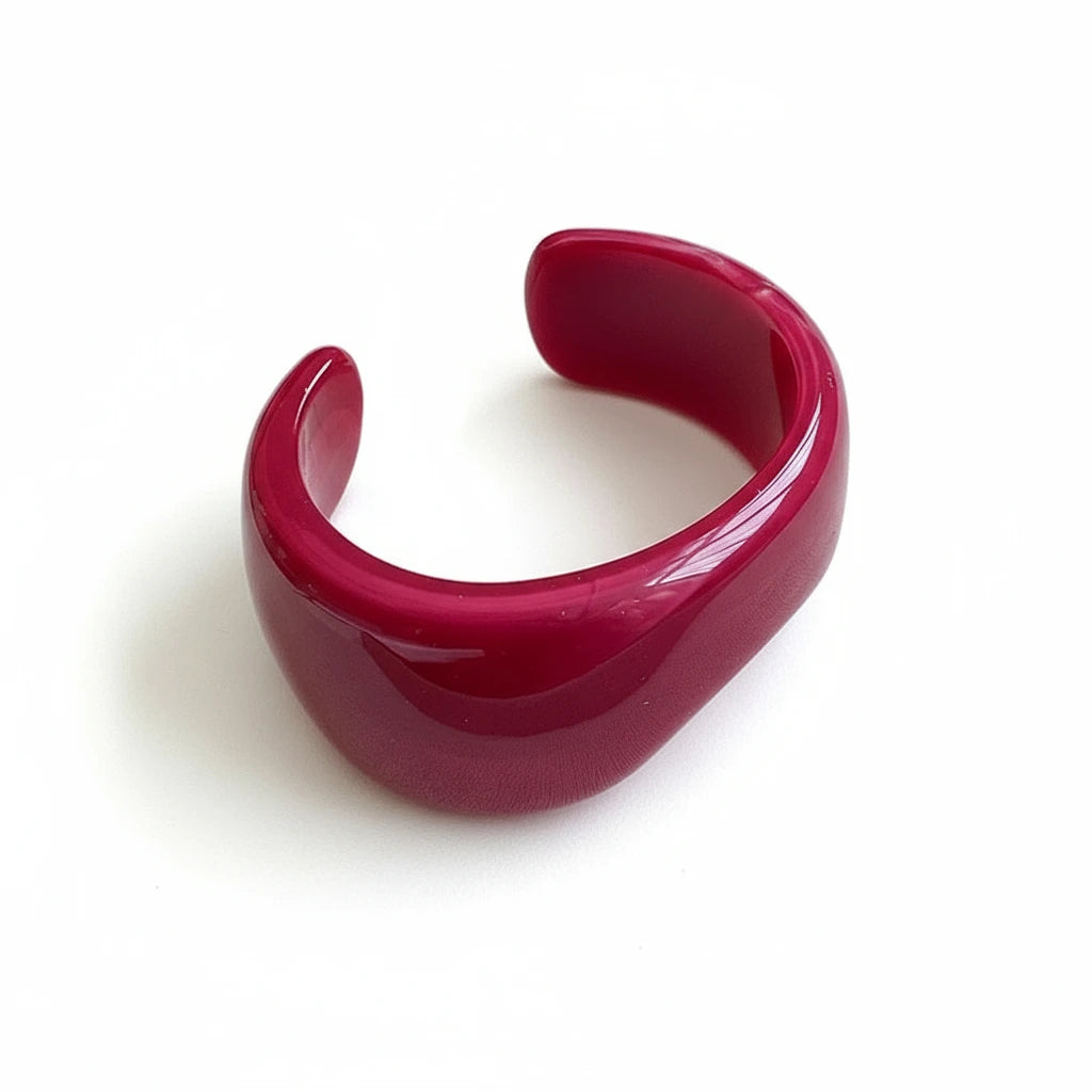 Dark red cuff bracelet on white surface