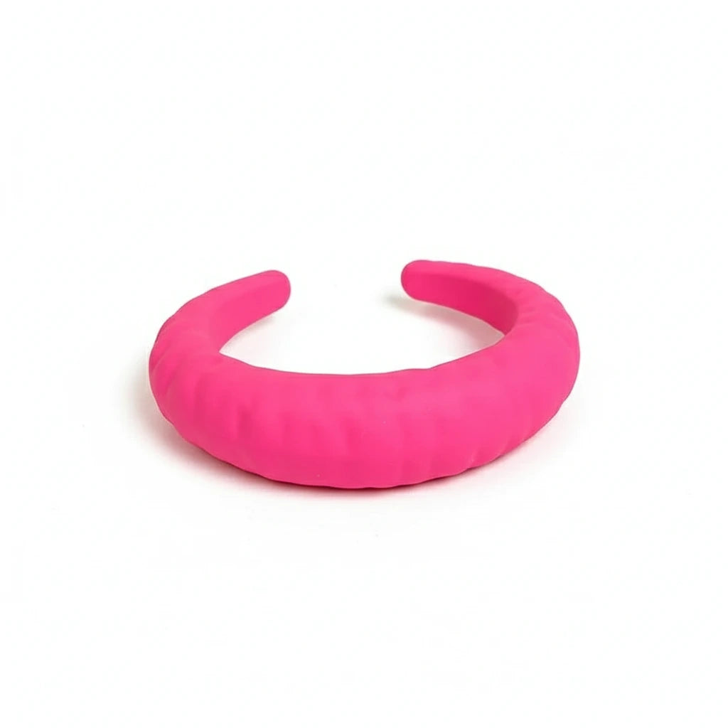 Pink resin cuff bracelet on a white surface 