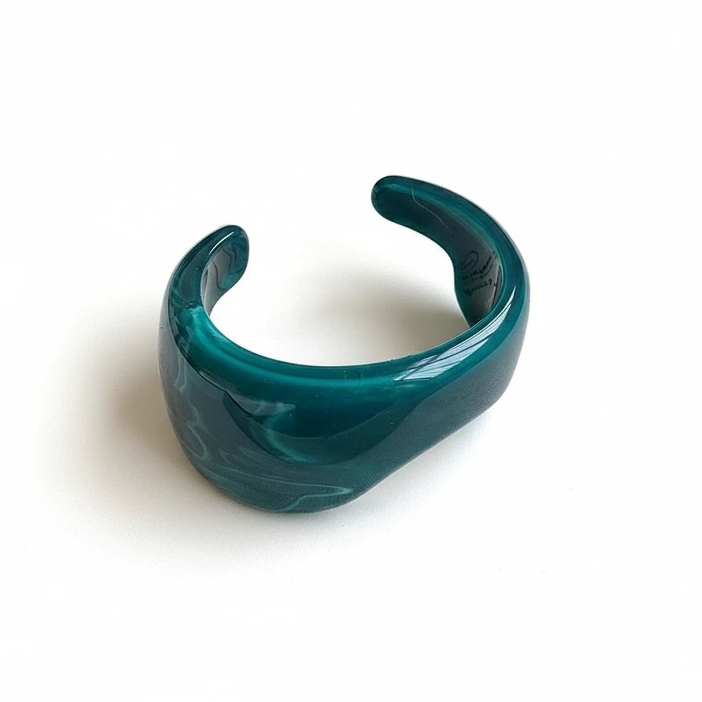 dark green cuff bracelet on white surface