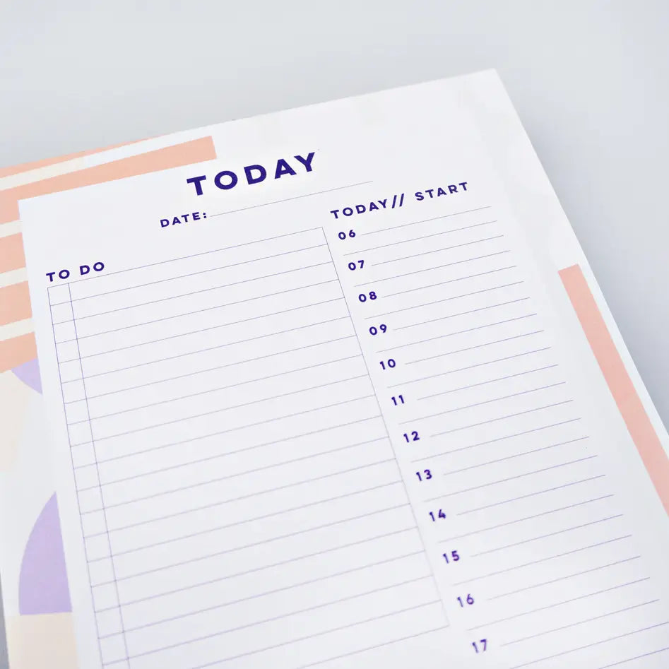 top of planner pad spots + stripes by the completist, with abstract light orange stripes and white dots