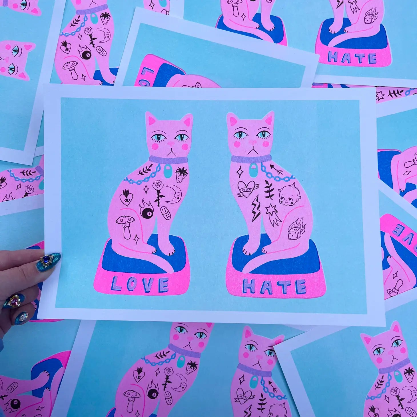 handmade print love/hate cats by Amy Hastings, light blue background with two pink tattood cats
