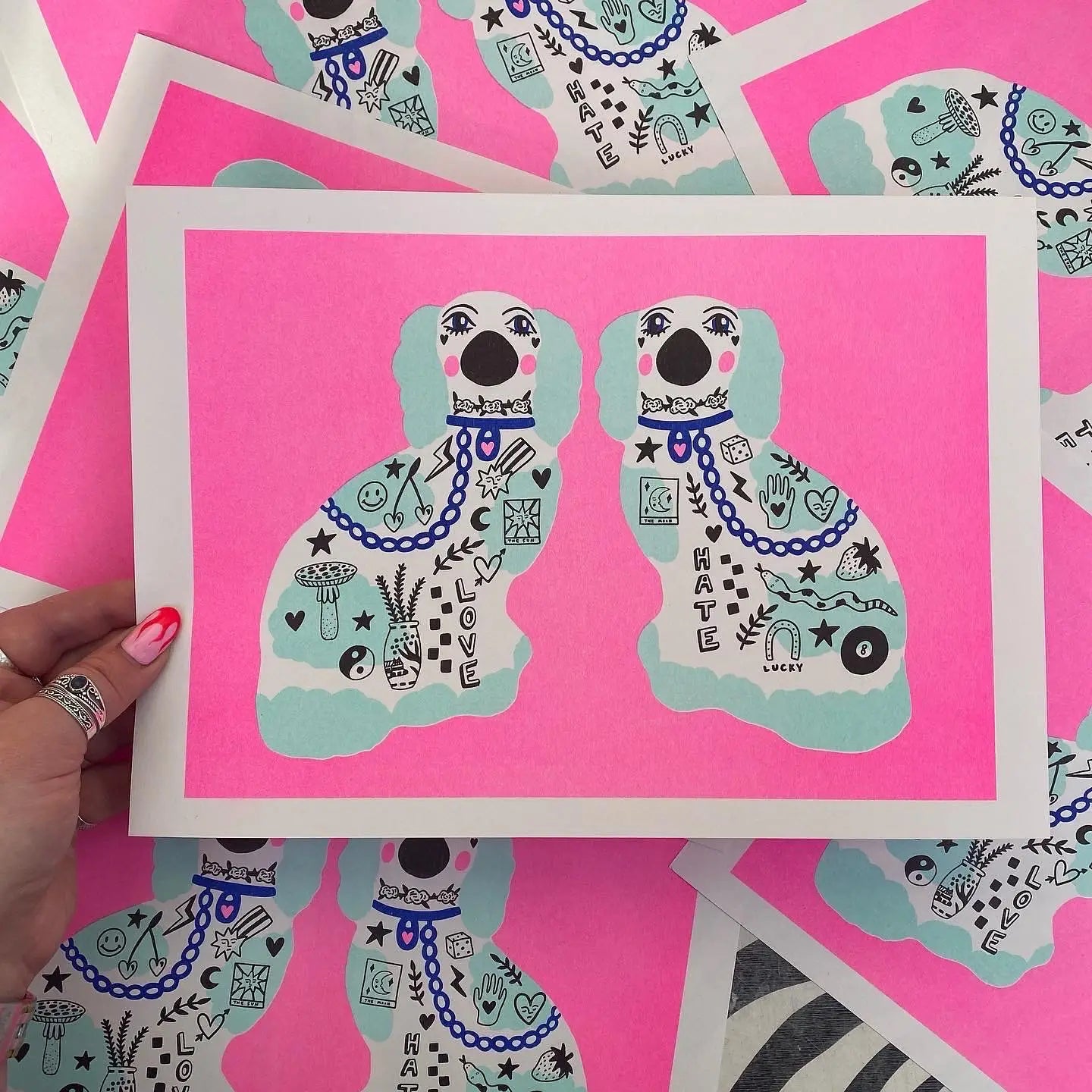 handmade print stephordshire dogs by Amy Hastings, neon pink background with two light blue tattood dogs