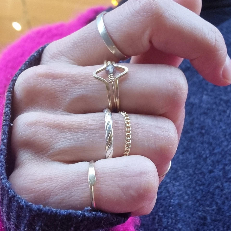 hand of stacking rings by BonBon Boutique, with gold filled stacking rings hug, twisted, plain jane 1.0 chain ring, wave, sugared and silver name it rings